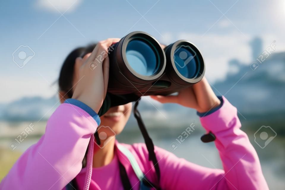 Asian Woman looking though binoculars