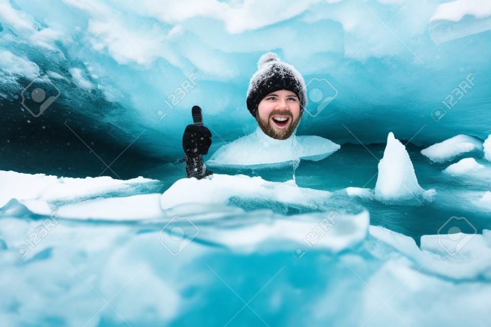 겨울 수영. 얼음 구멍에 있는 용감한 남자