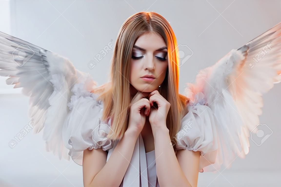 영과 멋진 금발 소녀 천사의 흰색 날개를 가진 이미지.