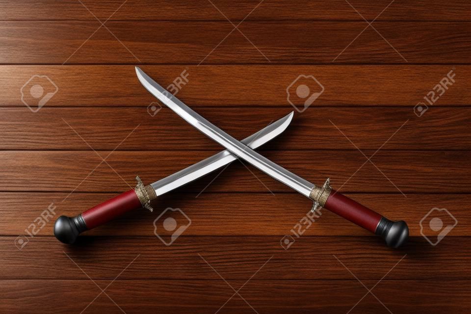 Cossack saber on wooden background, top view.