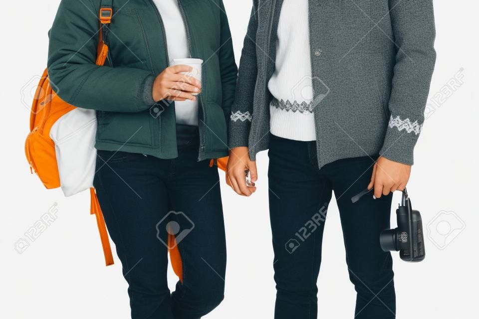 cropped shot of young tourists holding camera and coffee to go isolated on white