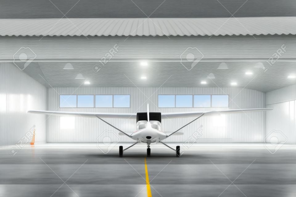 Pequeño avión blanco moderno de pie en el hangar