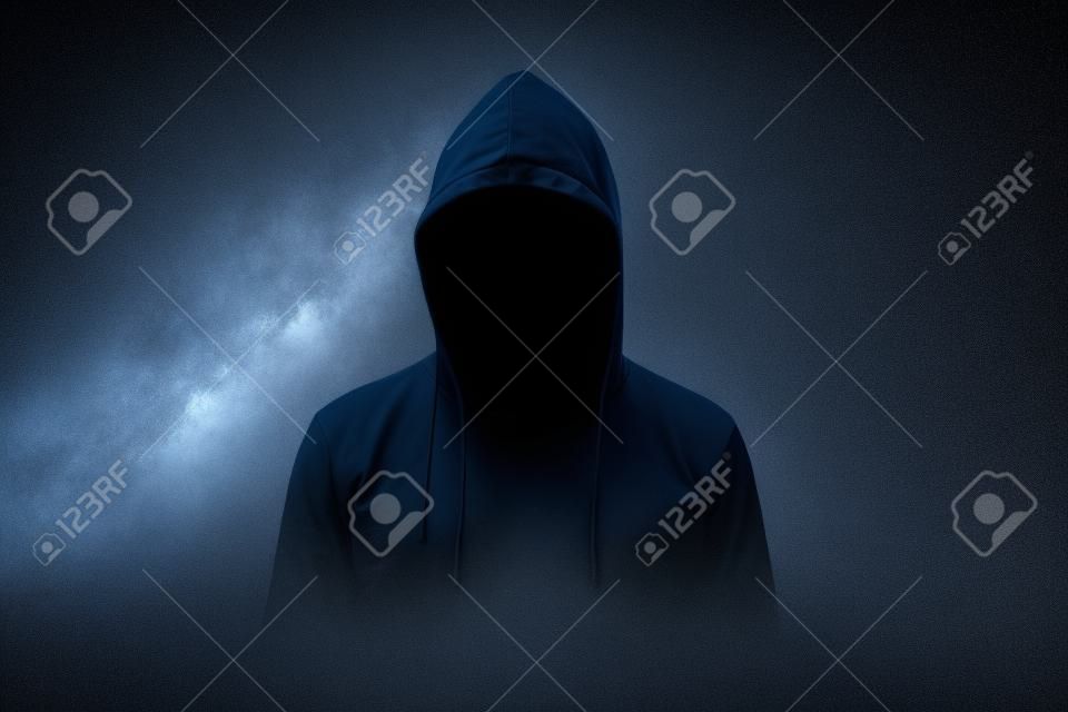 homem sem rosto em hoodie em pé isolado no preto