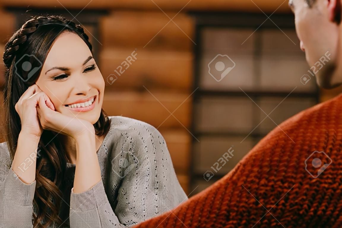 selective focus of smiling woman looking at man