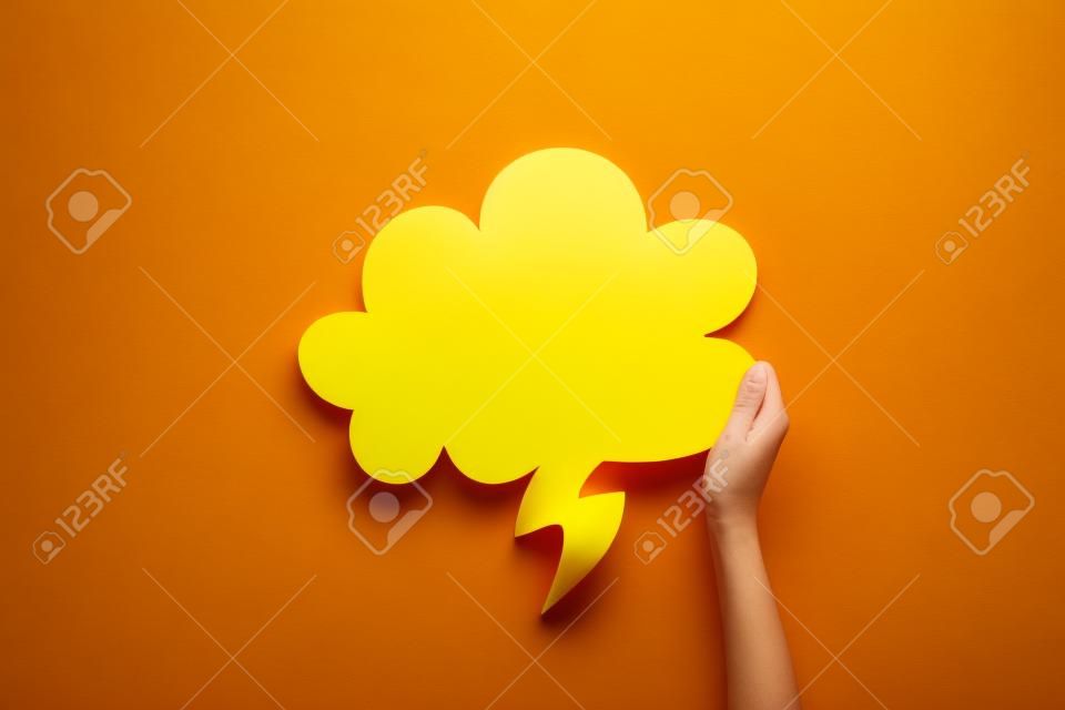 top view of empty yellow thought bubble on red background