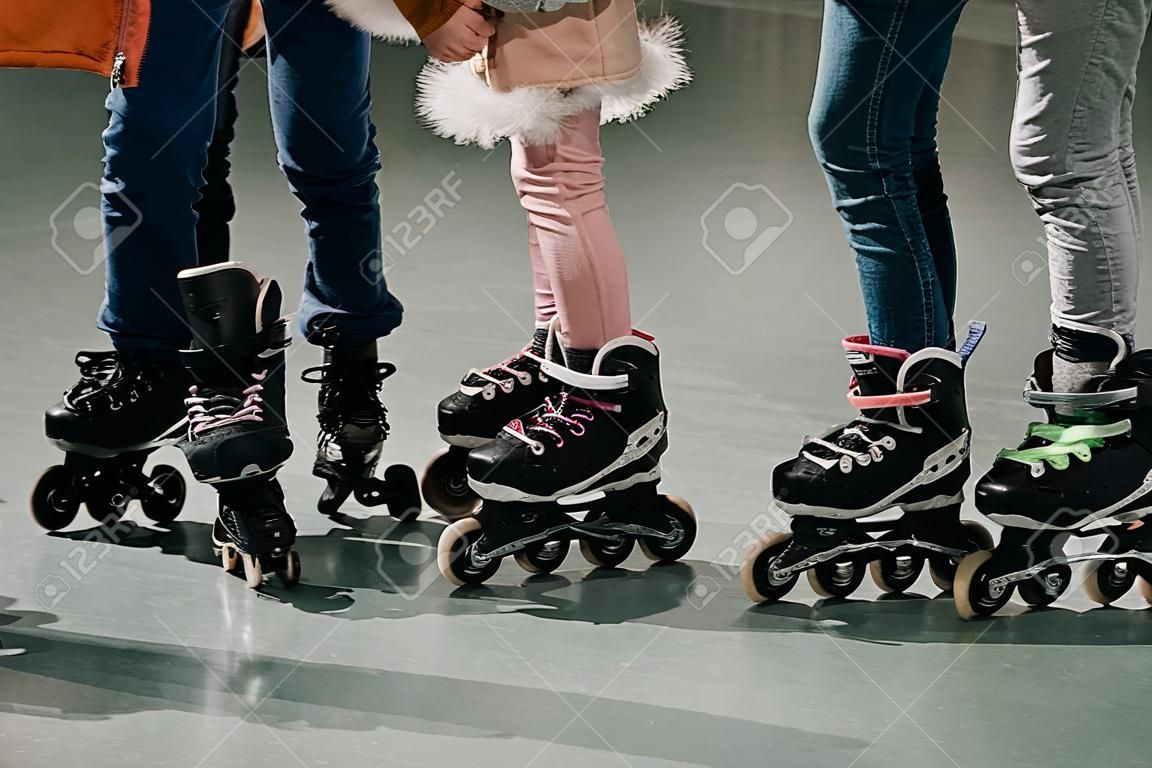Cropped shot of several kids skating on rink