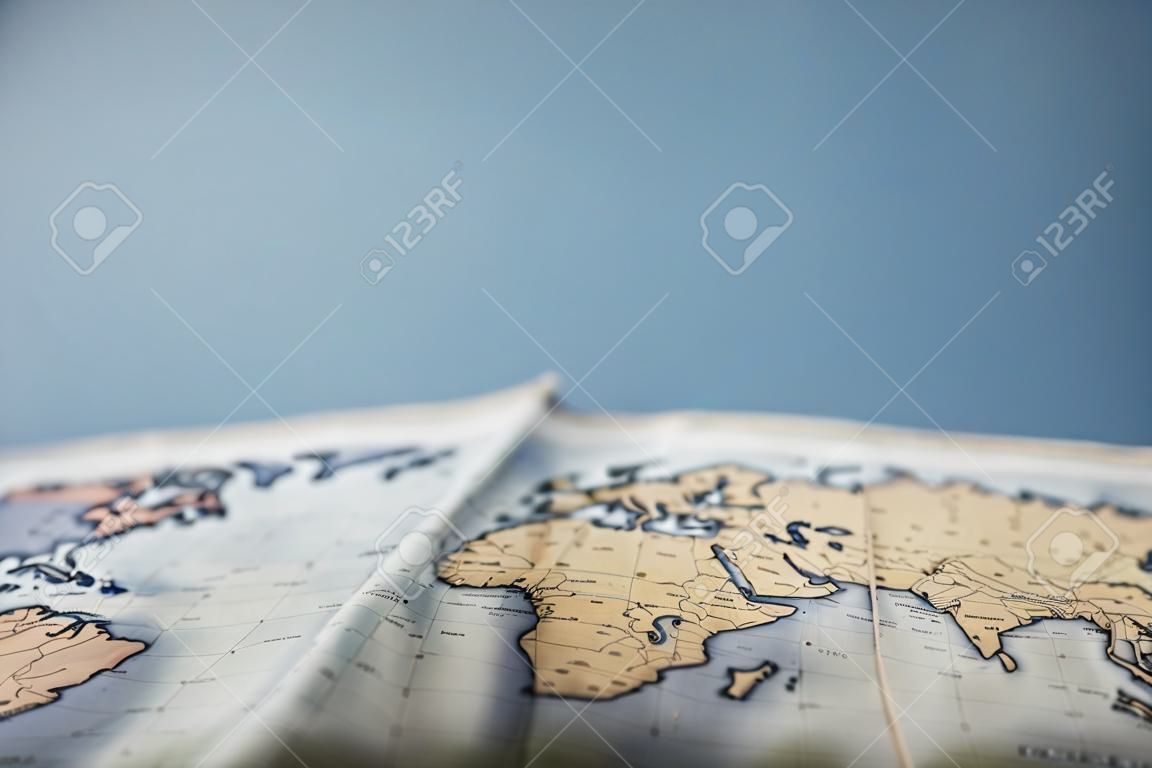 Selective focus of world map with copy space isolated on blue