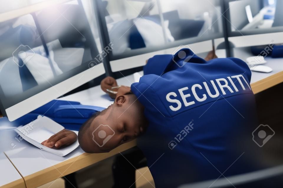 selective focus of guard sleeping in uniform at workspace
