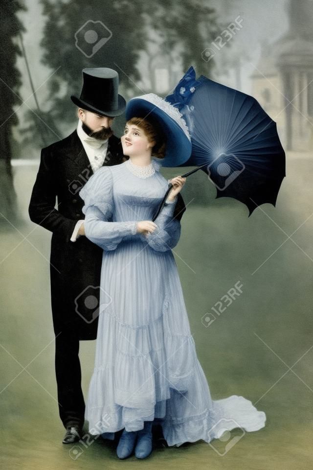 bell'uomo vittoriano in piedi con una donna attraente che tiene l'ombrello?