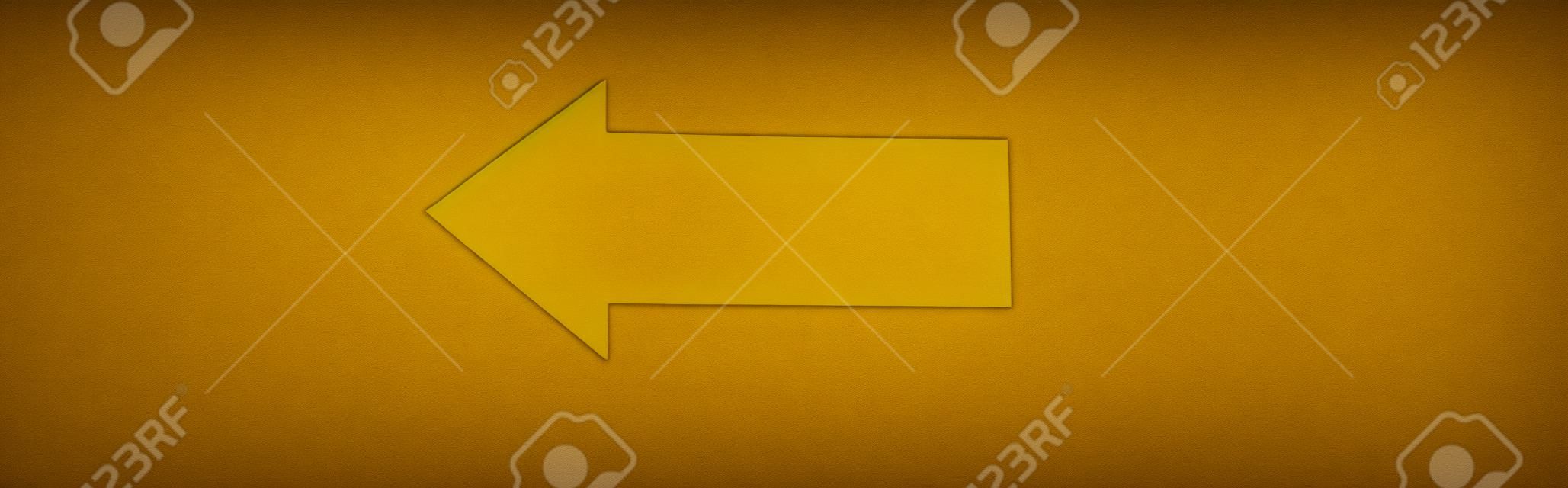 panoramic shot of yellow directional arrow isolated on black