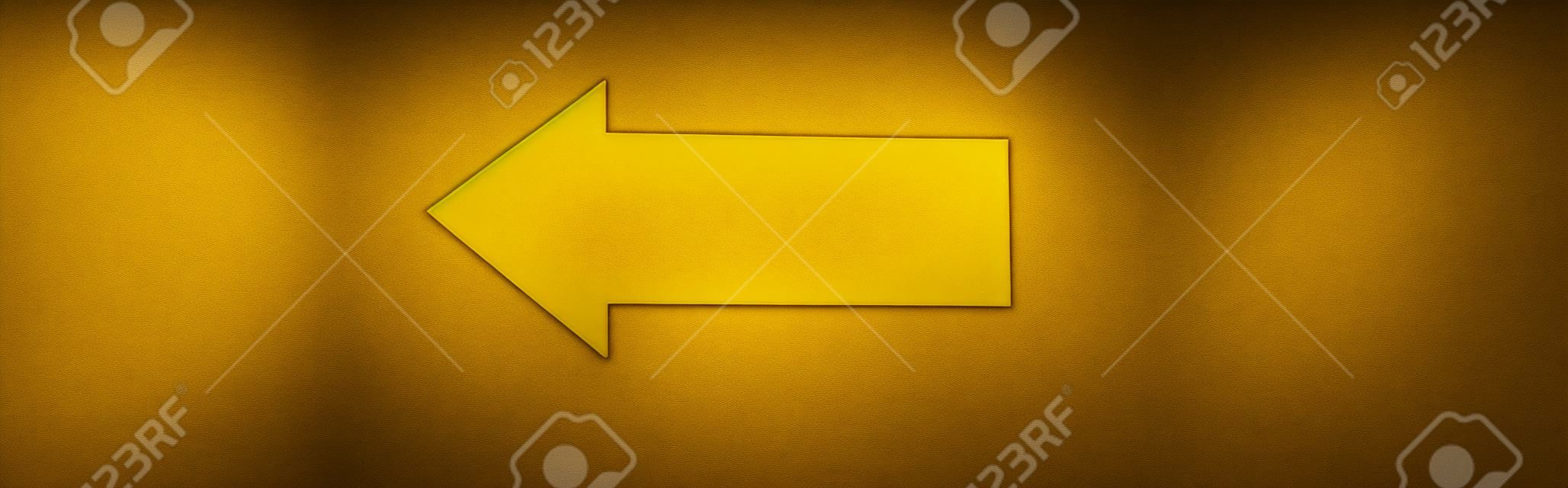 panoramic shot of yellow directional arrow isolated on black