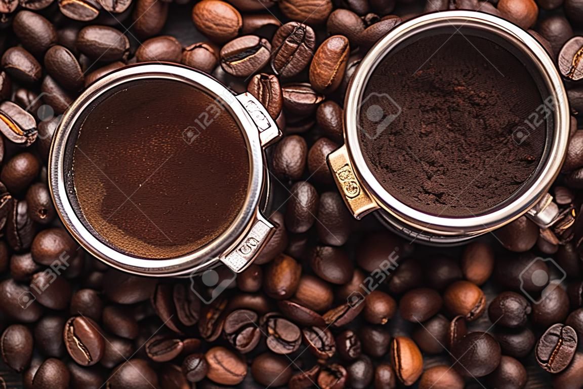 top view of fresh roasted coffee beans and ground coffee in filter holder on wooden table