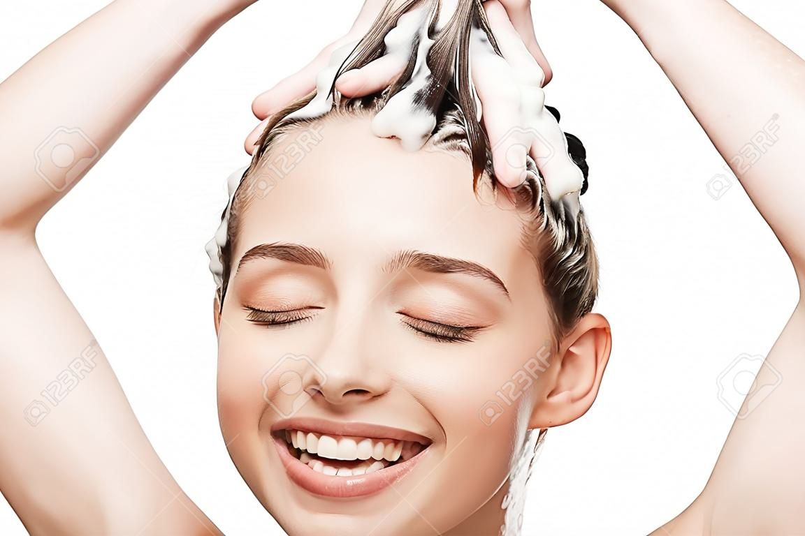 happy girl with closed eyes washing hair isolated on white