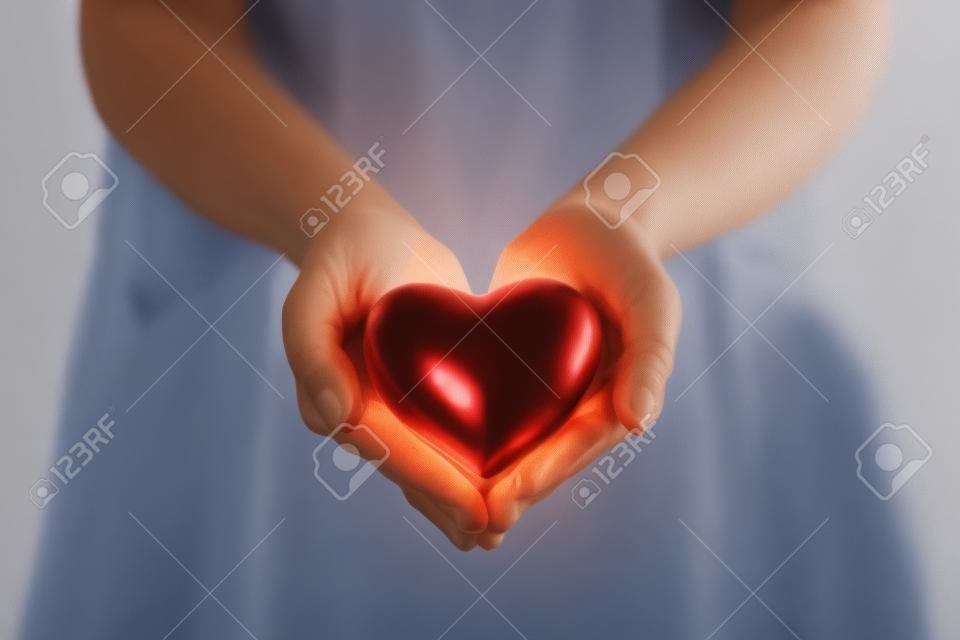 cropped view of doctor holding red heart