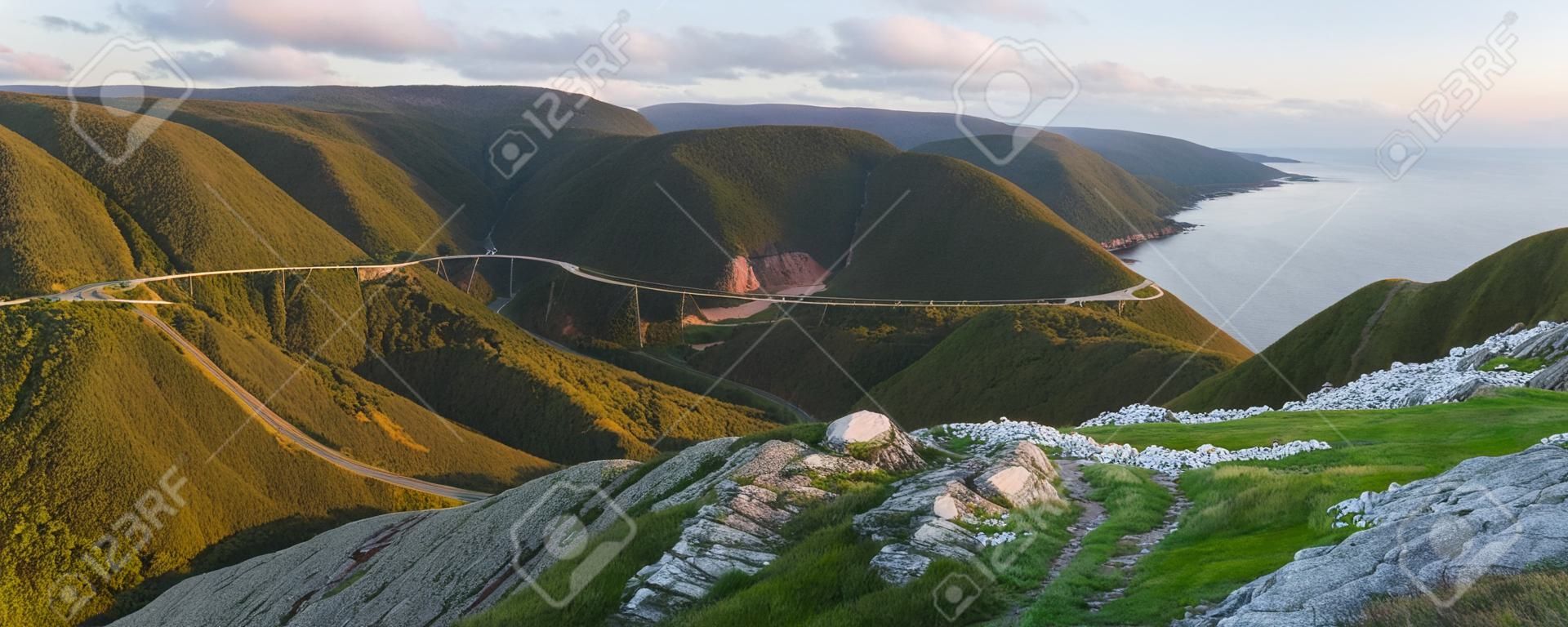 The winding Cabot Trail road seen from high above on the Skyline Trail at sunset in Cape Breton Highlands National Park, Nova Scotia