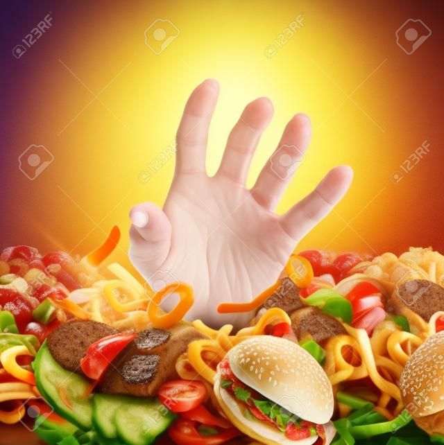 Obesity and overweight concept as the hand of a person emerging from a heap of unhealthy fast food and desperately reaching out for diet and dieting help as a symbol of bad nutrition proplems 