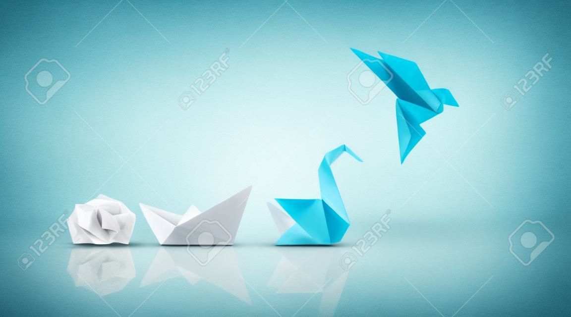 Transformacja i sukces lub zmiana, aby odnieść sukces koncepcja i przywództwo w biznesie poprzez innowacje i ewolucję umiejętności jako zmięty papier przekształcający się w łódź, a następnie łabędź i latający ptak jako metafora.