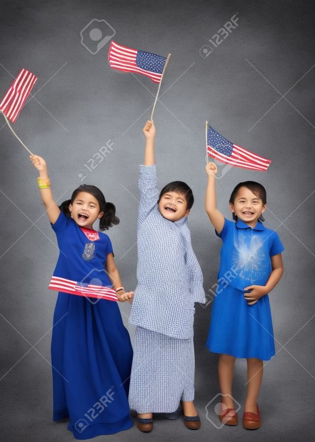 Full lenght of three kids holding flag