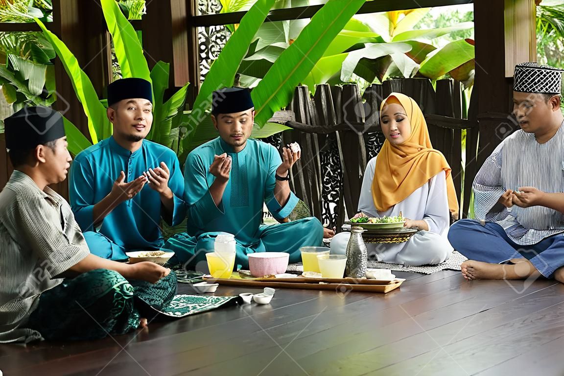 group of malay family breaking the fast together