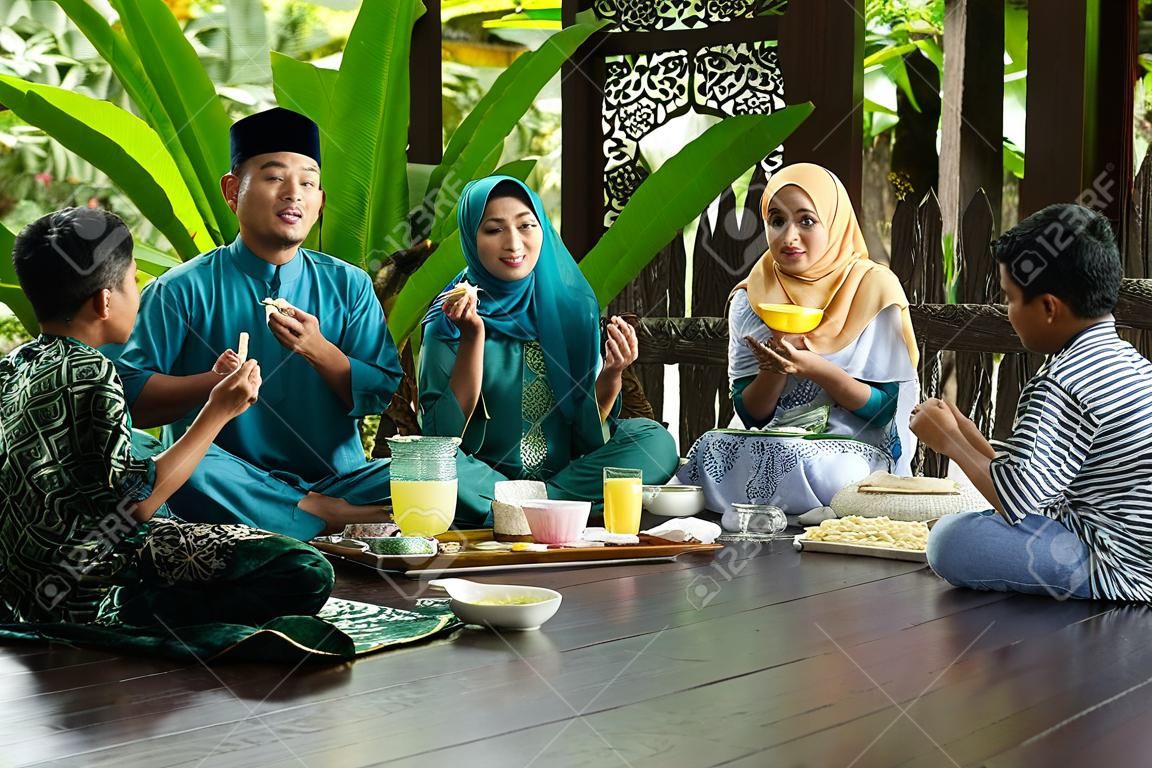 group of malay family breaking the fast together