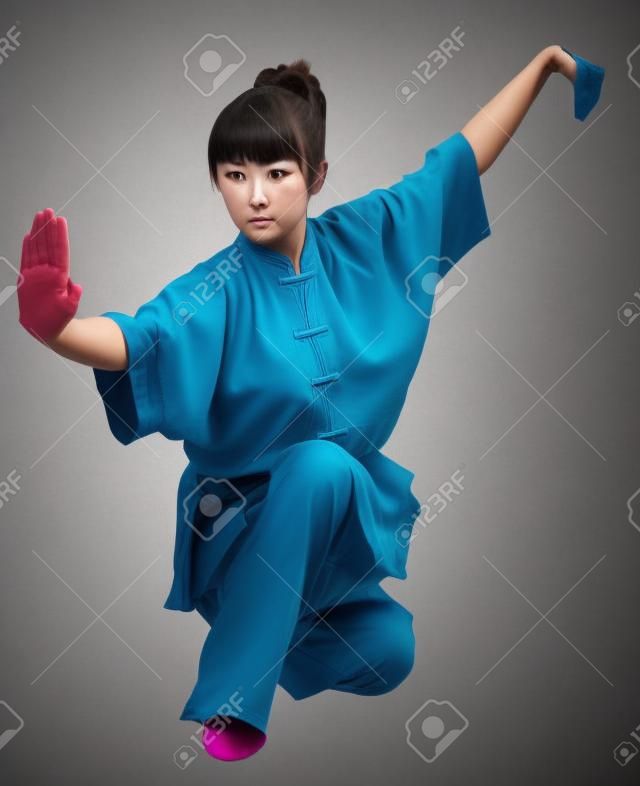 young woman makes kung-fu exercise isolated