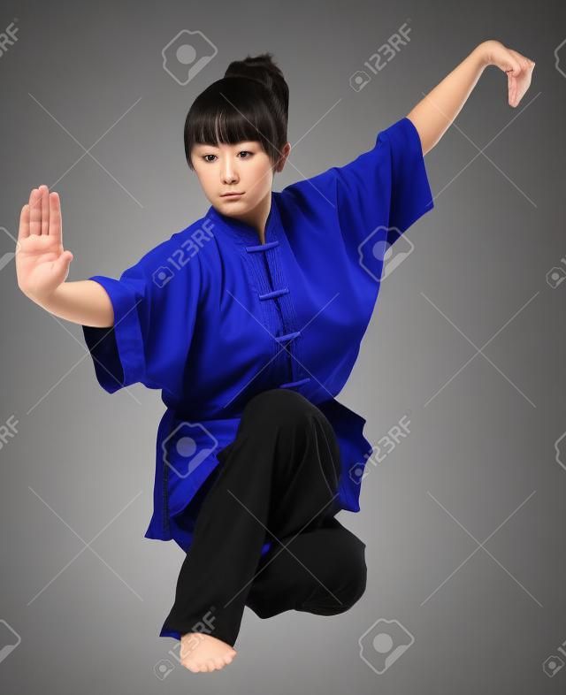young woman makes kung-fu exercise isolated