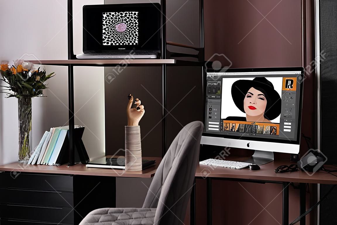 Retoucher's workplace. Computer with photo editor application, camera and graphic tablet on table in office