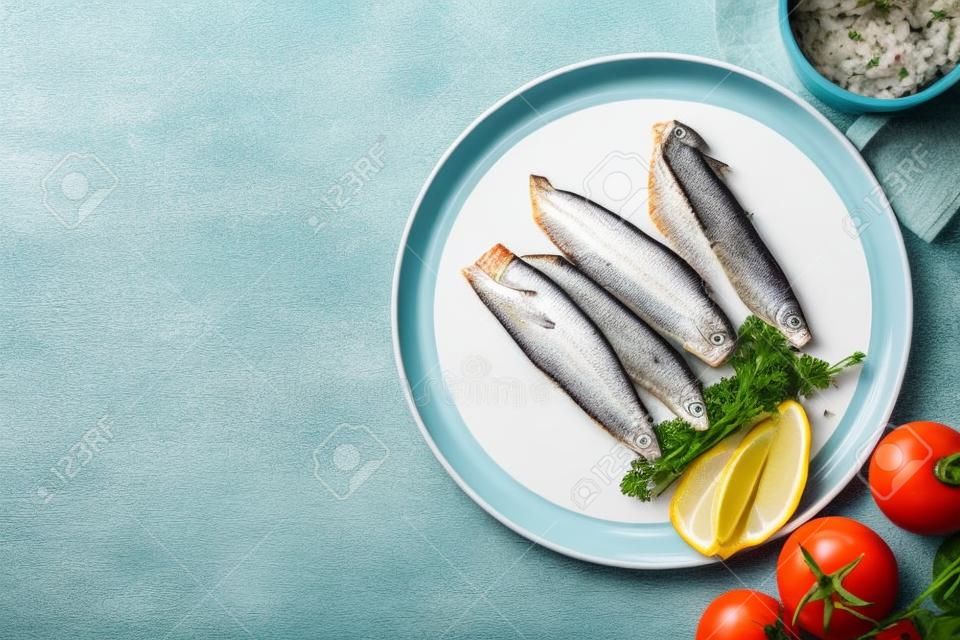 Canned mackerel fillets served on white tiled table, flat lay. Space for text