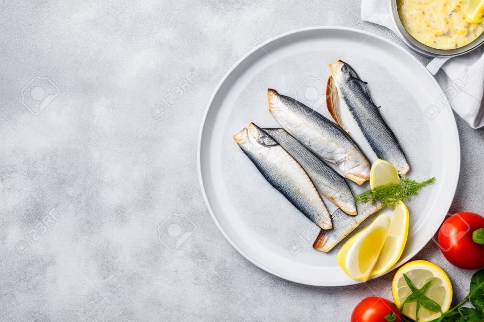Canned mackerel fillets served on white tiled table, flat lay. Space for text