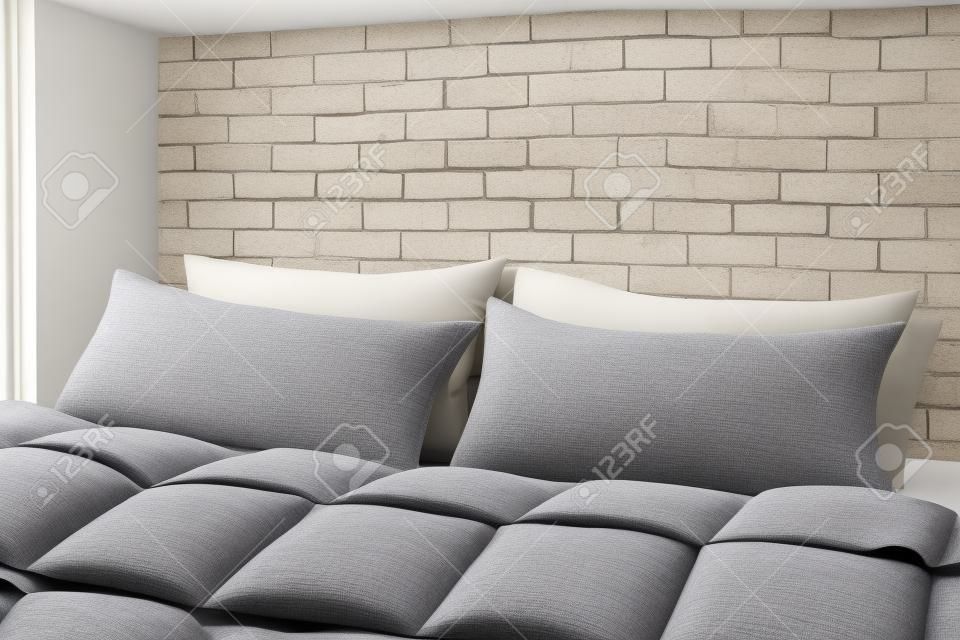 Large comfortable bed with pillows and blanket near white brick wall indoors. Stylish interior