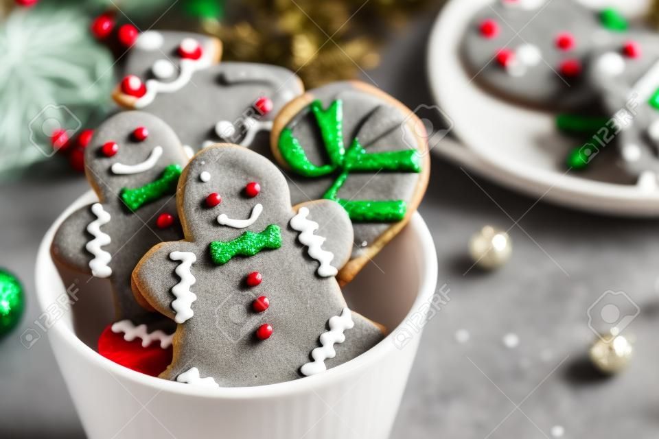 Tasty homemade Christmas cookies in cup on grey table, closeup view