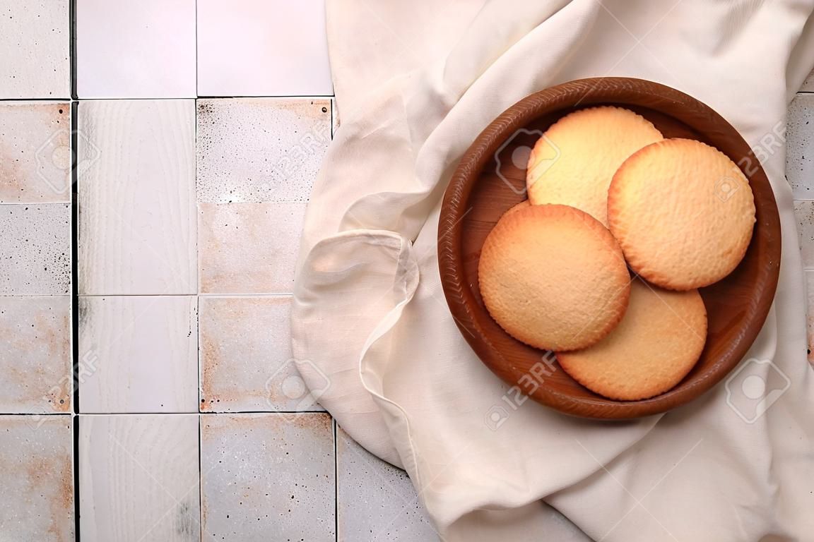 Delicious Danish butter cookies on white tiled table, top view. Space for text