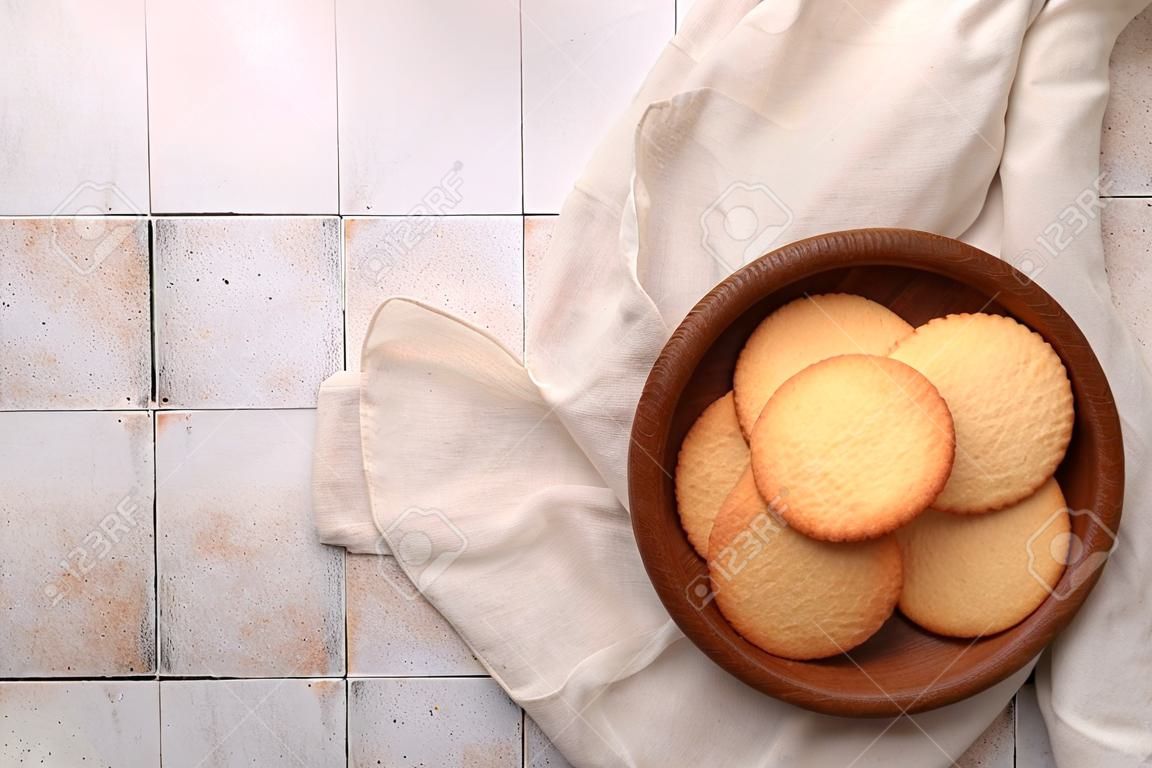 Delicious Danish butter cookies on white tiled table, top view. Space for text