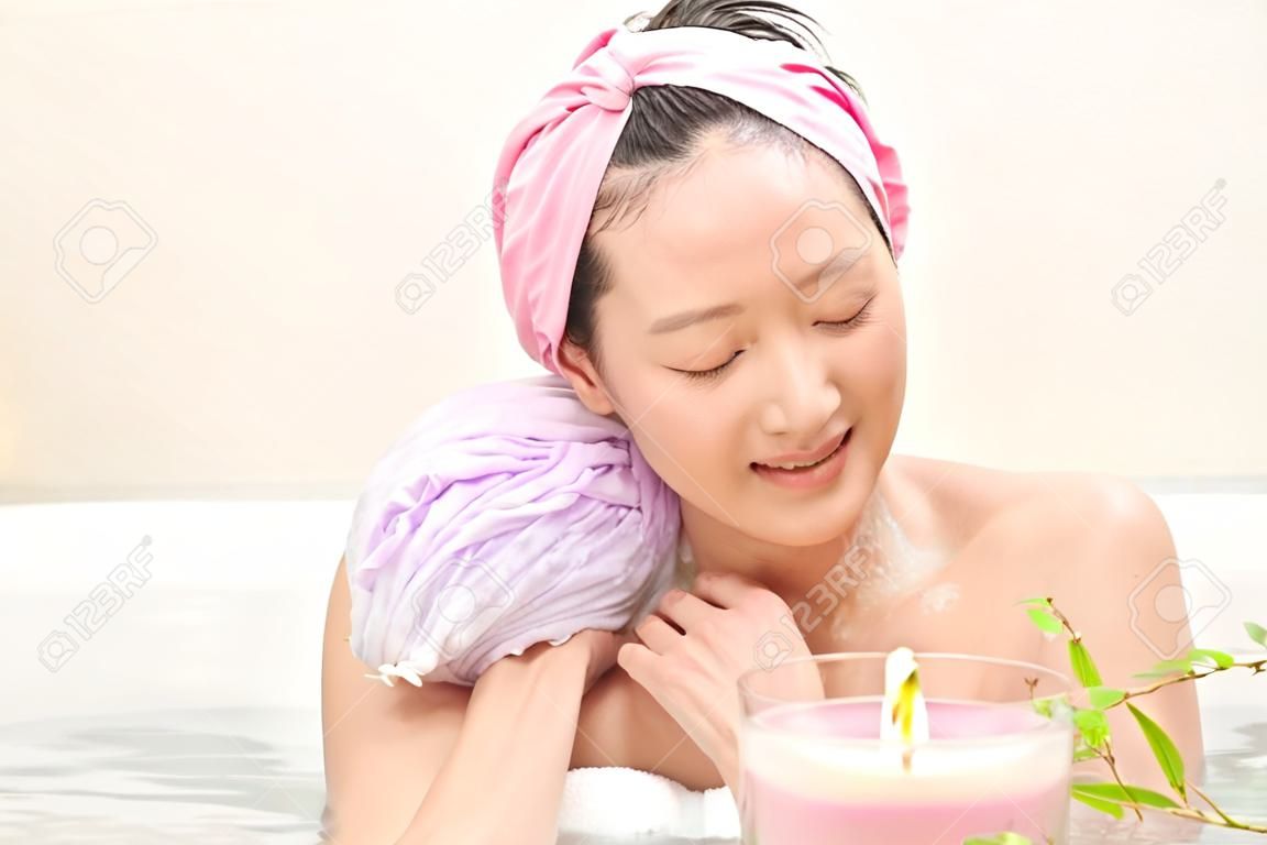 Young beautiful woman taking relaxing bath