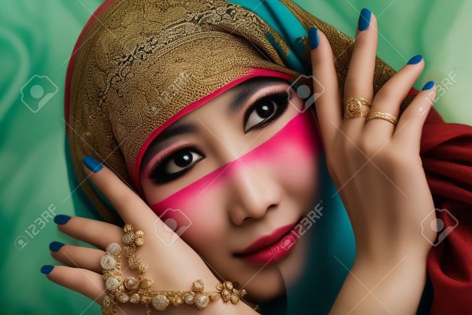 Retrato de una mujer oriental hermosa en un pañuelo tradicional, primer plano.