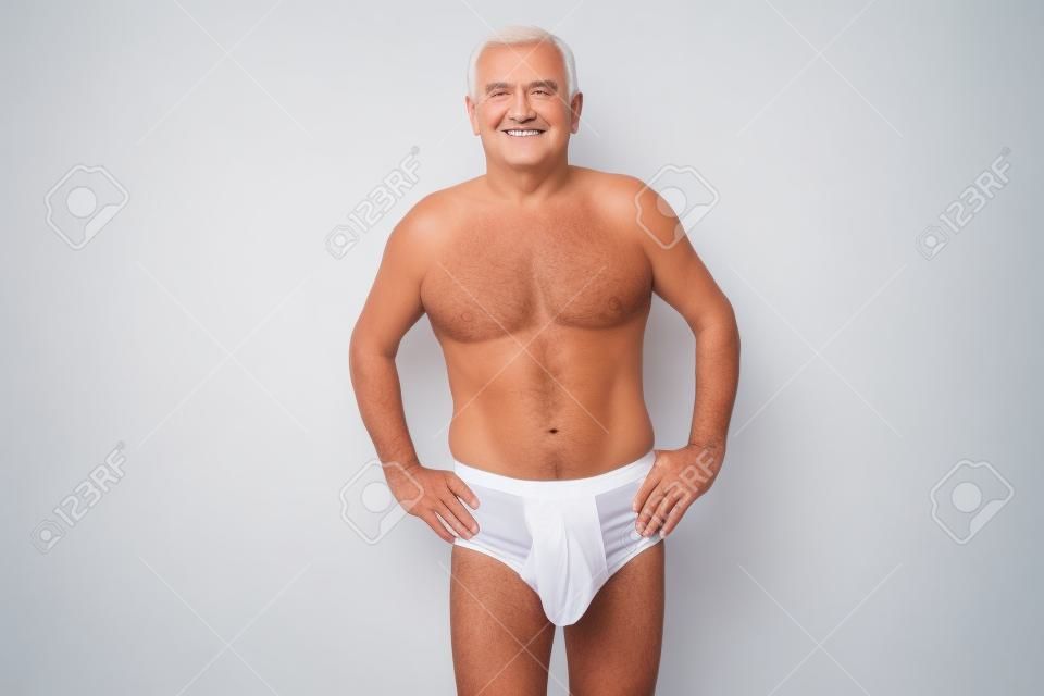 Senior posing in white underwear isolated on white background