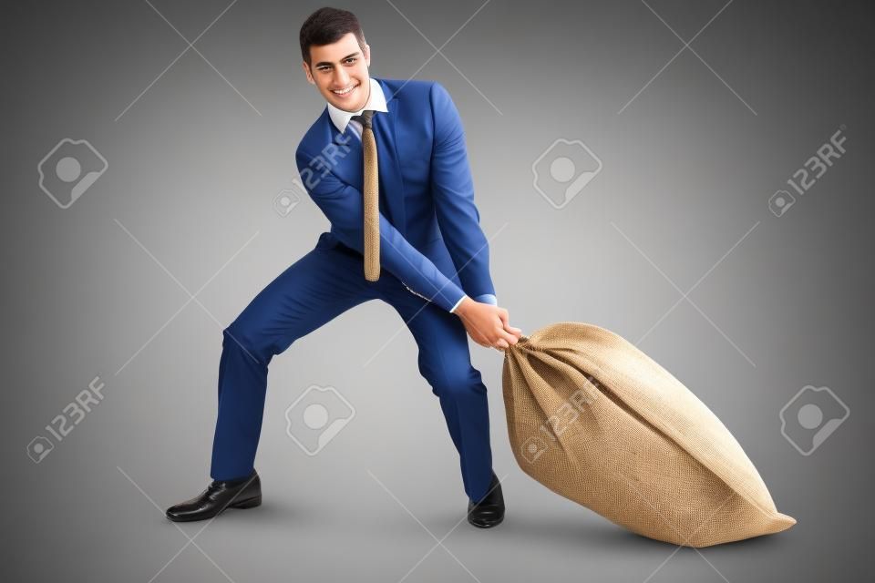 Young businessman pulling a burlap sack isolated on white background