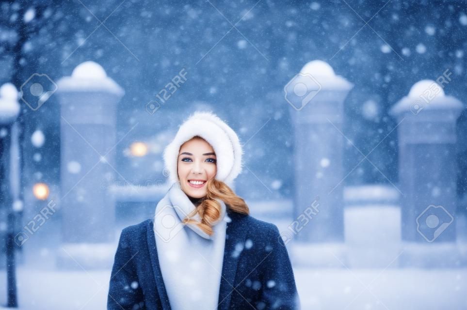 A young woman is walking in the street in winter