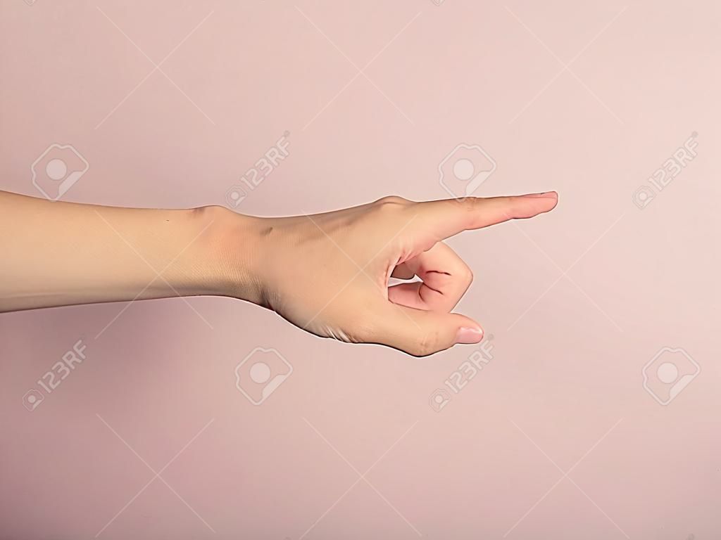 A young female hand is pointing