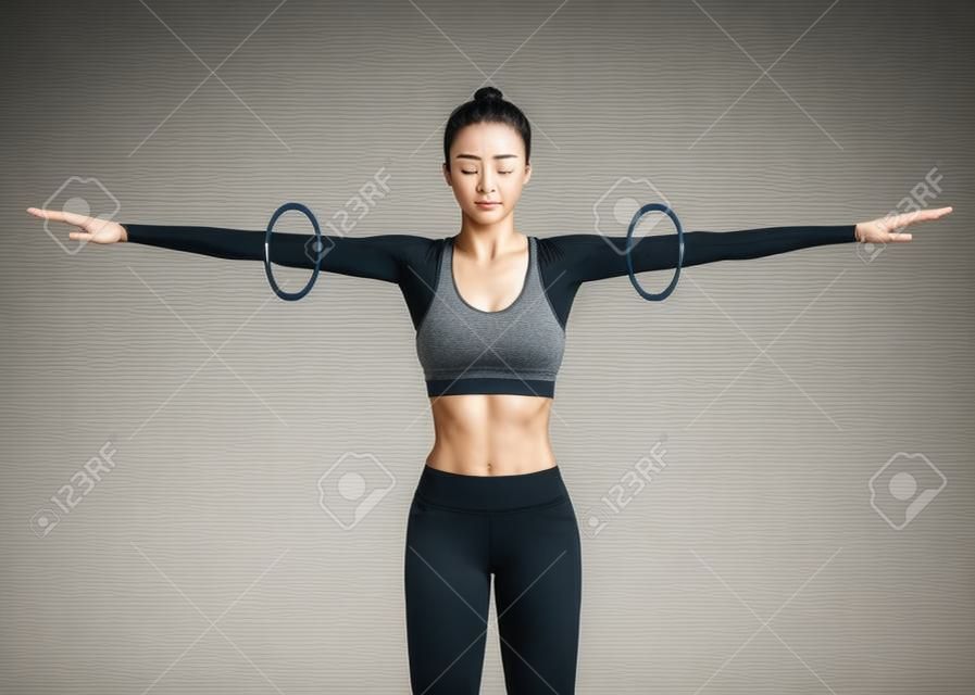 Close up of Woman doing exercise with arm circle posture for warm up. Rotation arms help to prevent injuries and prepare your body for strength training.
