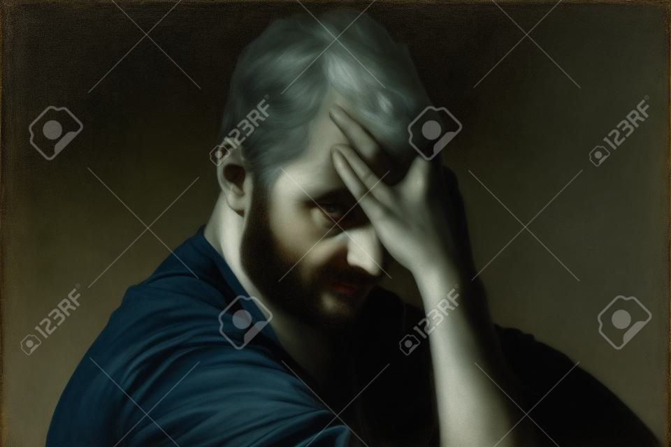 A portrait of man sitting in dark and contemplating