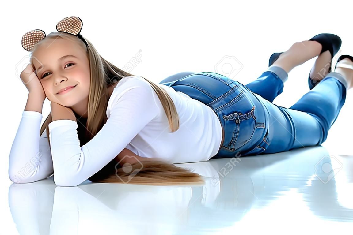 A teenage girl lies on the floor