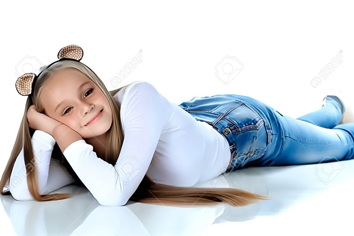 A teenage girl lies on the floor
