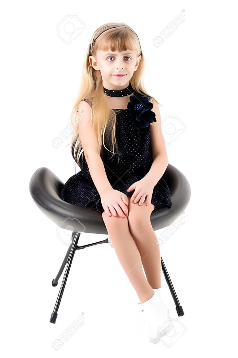 Little girl is sitting on a chair