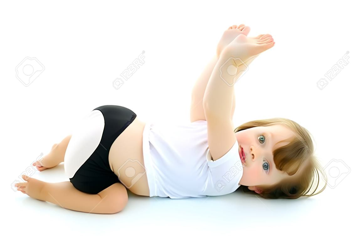 Charming little girl doing gymnastic exercises in the studio on