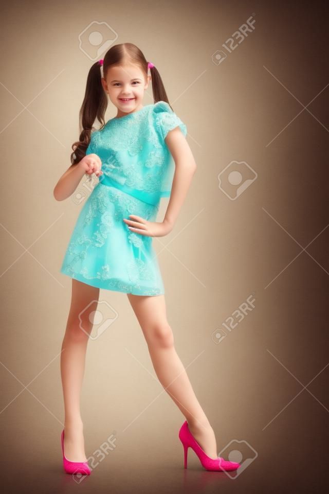 Cheerful little girl in large shoes taken from her mother.