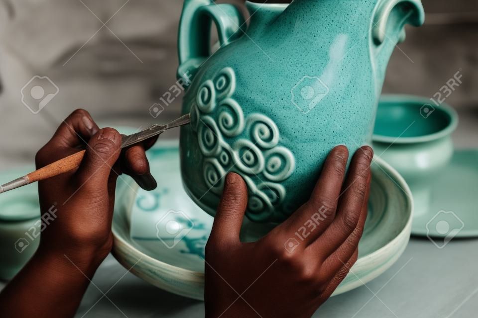 potter produces ceramic ware out of clay - handmade