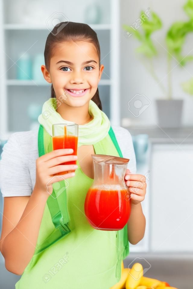 
Smiling girl holding pitcher of homemade juice