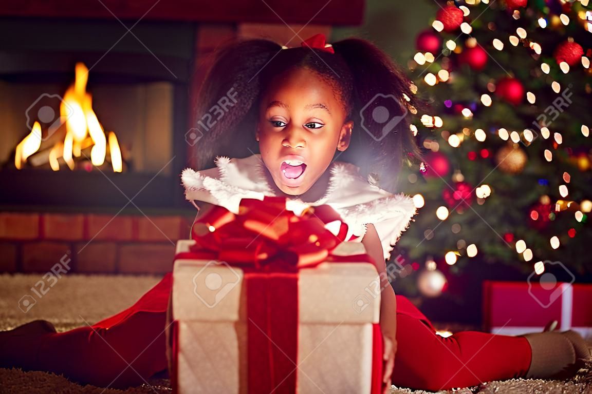 surprise girl opening Christmas magic presents