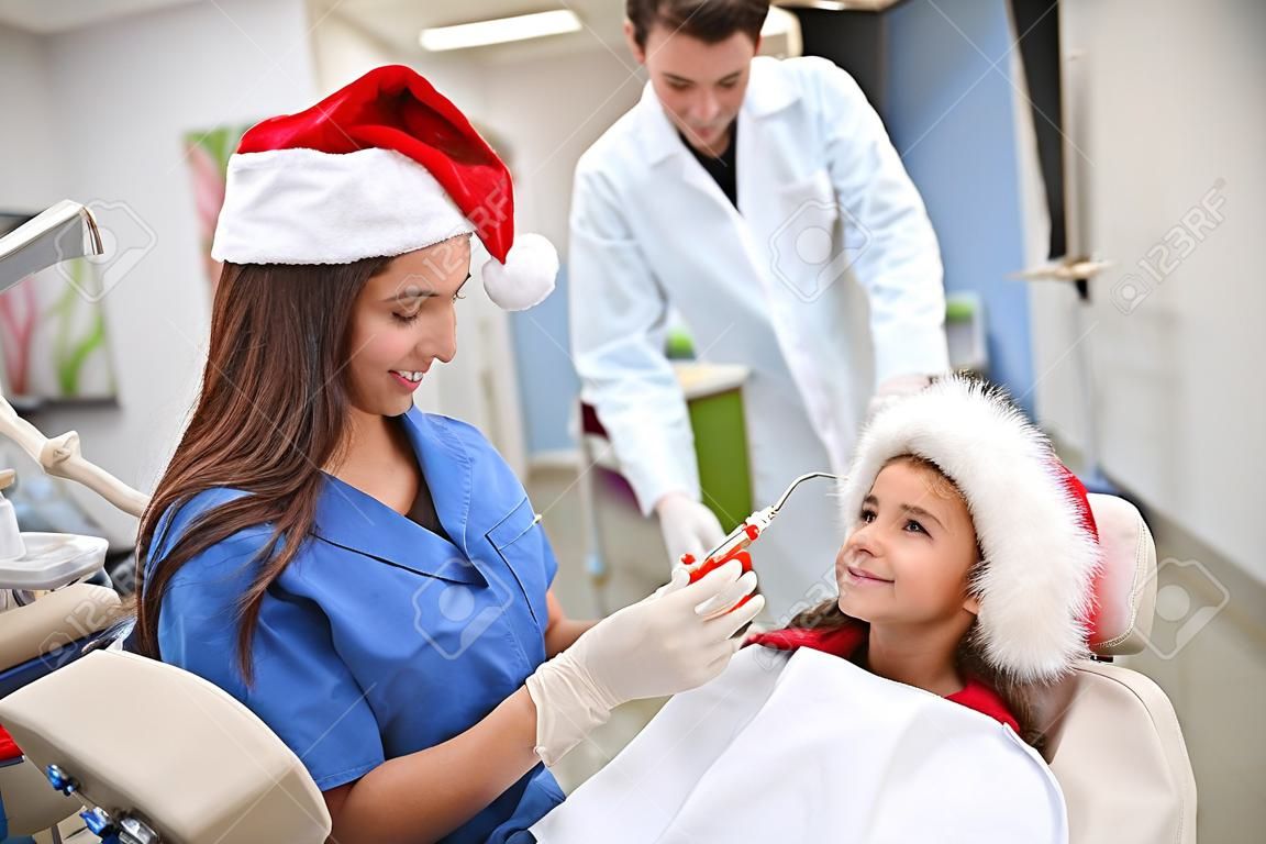 Młoda dziewczyna u dentysty podczas świąt Bożego Narodzenia